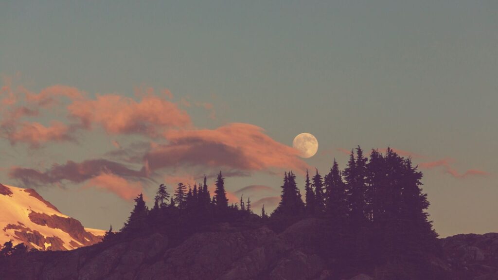 Moon in the sixth house represented by a full moon in a stunning landscape.