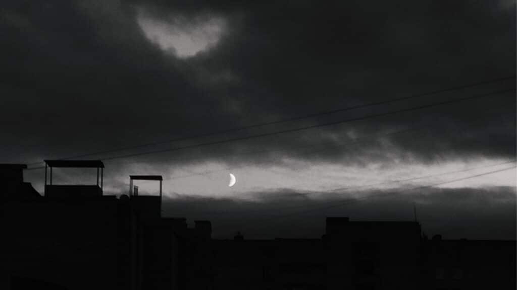 Black moon Lilith in Gemini represented by a dark night sky with the moon.