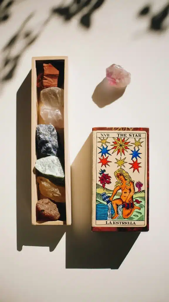 Tarot de Marseille card next to natural crystals, representing the deeper symbolic meaning of tarot beyond yes or no answers.