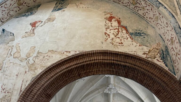 New Moon in Leo (July 2025): Meaning & Do/Don’t Horoscopes Leo New Moon 2025. A mural detail with faded red and blue medieval fresco over a brick archway.