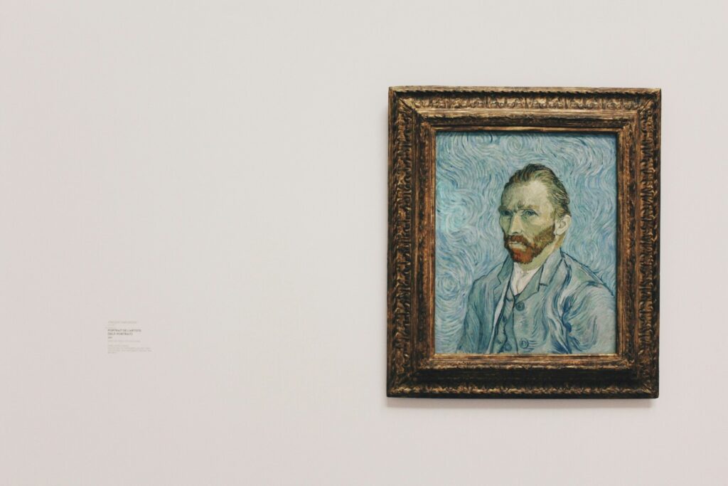 Framed portrait of Vincent van Gogh displayed on a white gallery wall