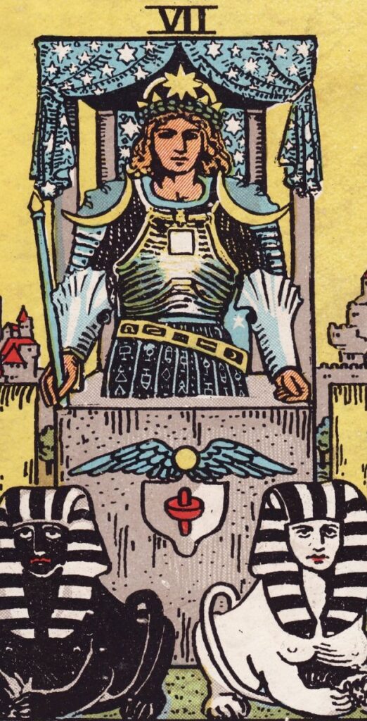 The Chariot card from the Rider-Waite tarot, with a figure in armor driving a chariot pulled by a black and white sphinx.