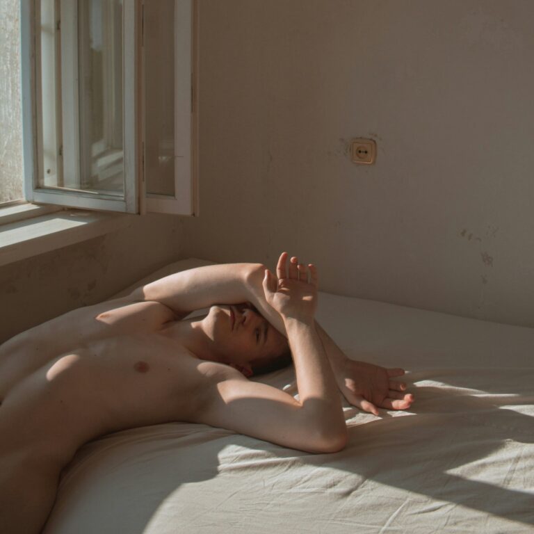 Venus in Capricorn: a person lying nude on a sunlit bed.