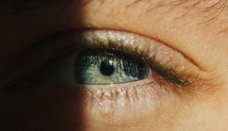 Black Moon Lilith in Taurus symbolized by a half-lit eye and shadow, representing desire, control, and embodiment