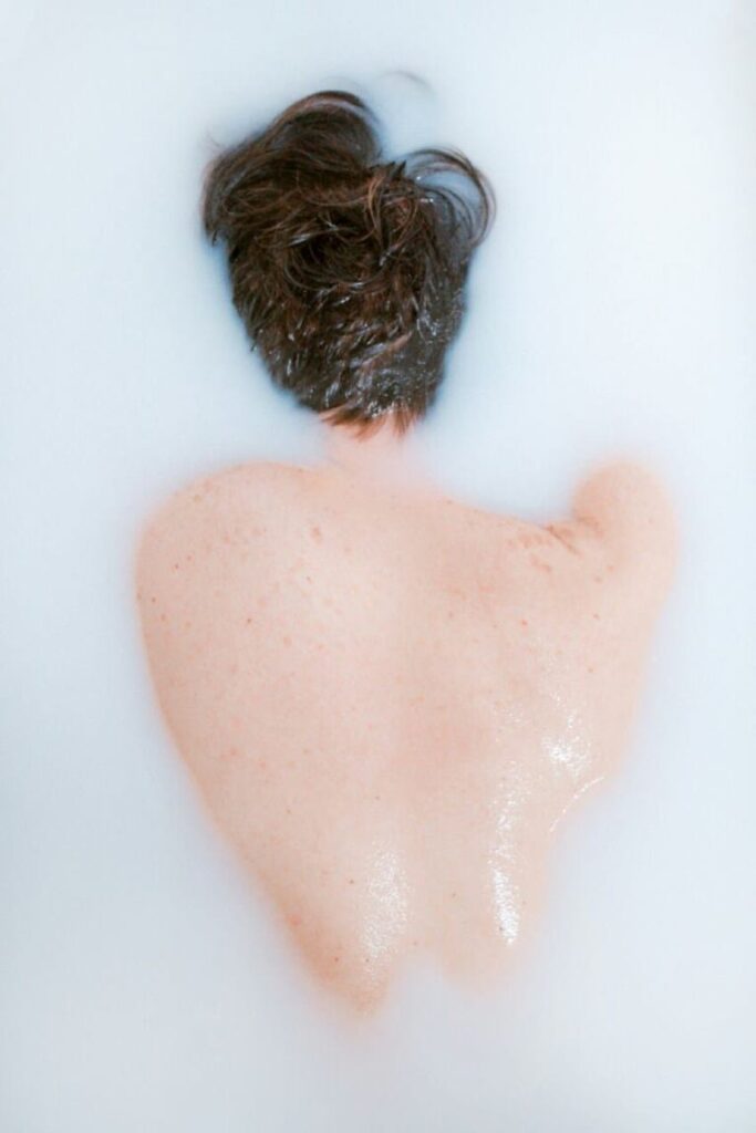 Neptune in the 5th house in your birth chart, dreamy and blurred figure in water symbolizing romance, creativity, and fantasy.