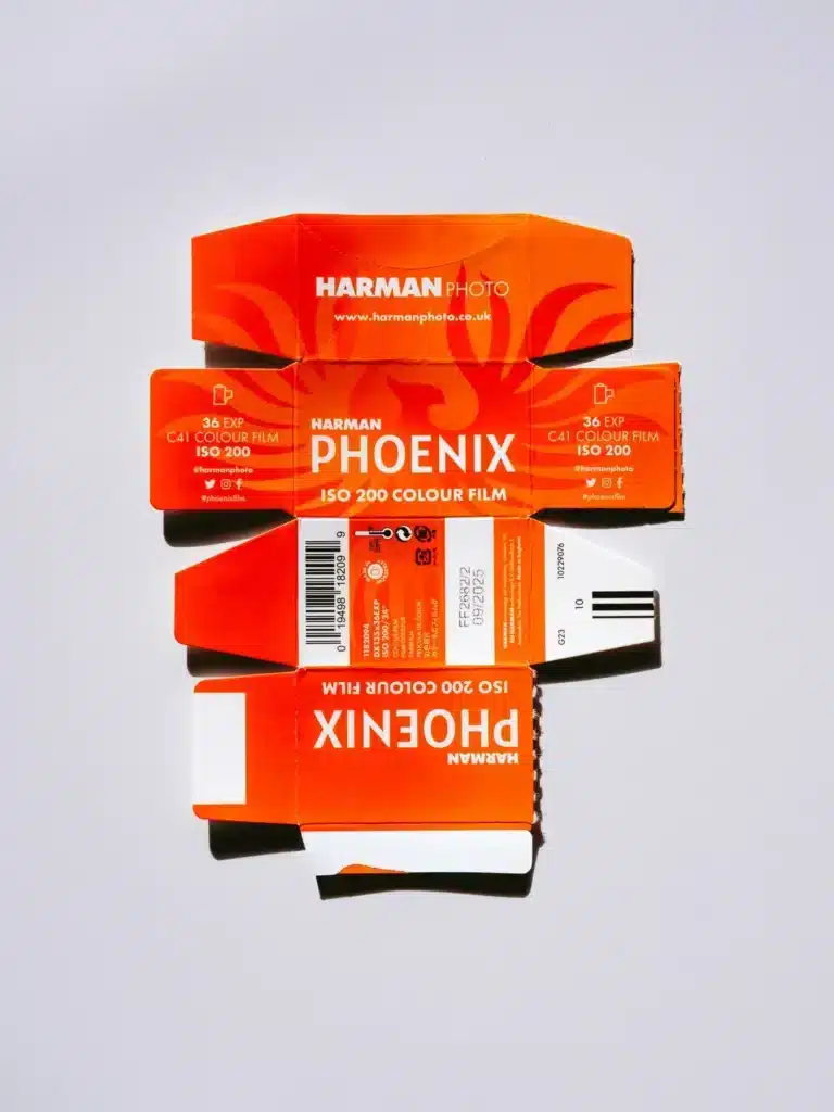 Mercury retrograde symbolism, open red vintage film roll packaging evoking the past, memory, and reflection during retrograde cycles.