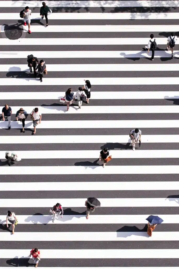 Career astrology concept: people crossing street different paths.