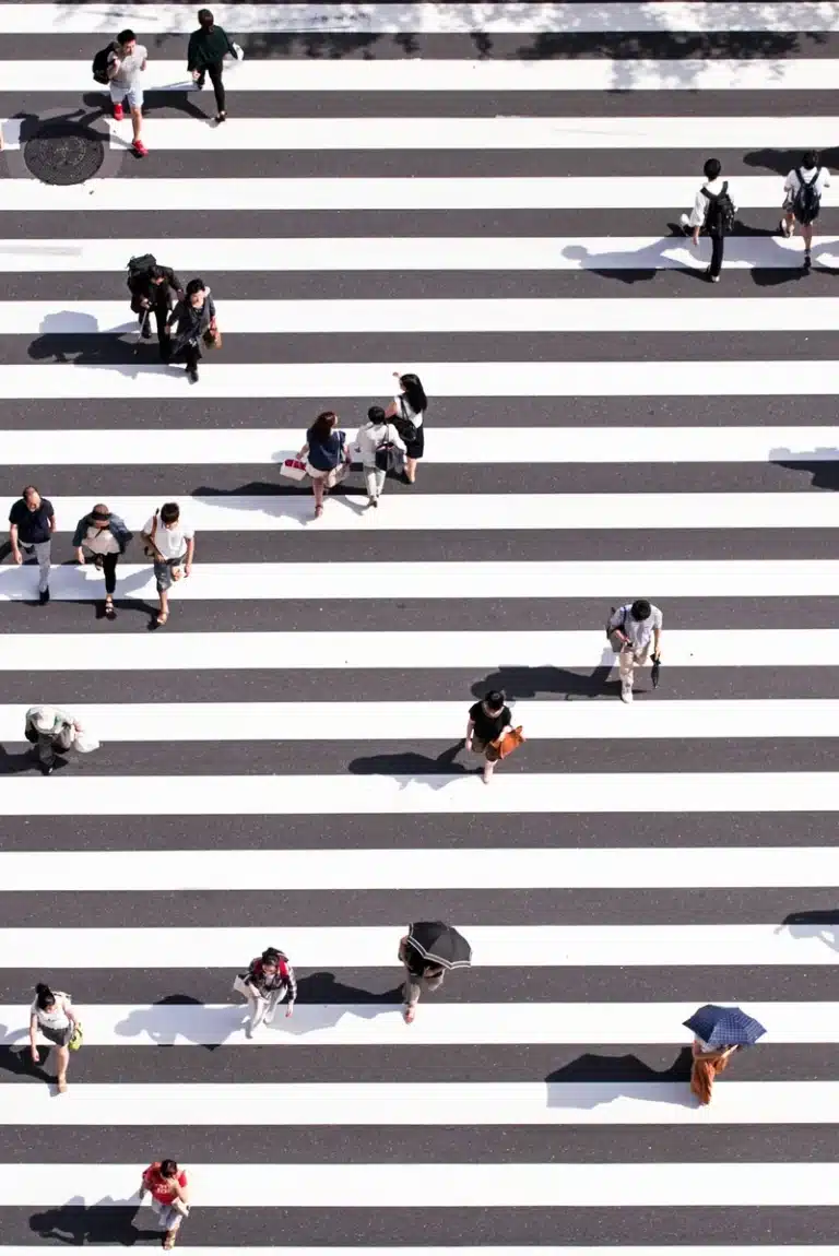 Career astrology concept: people crossing street different paths.