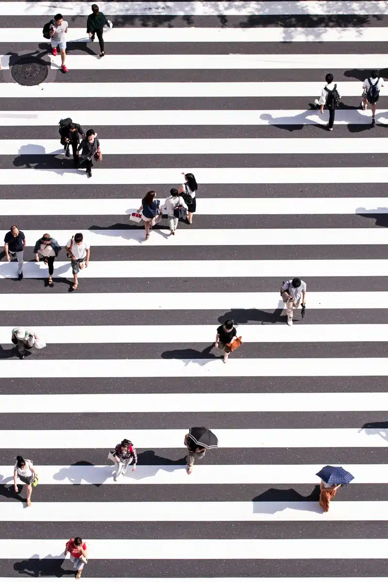 Career astrology concept: people crossing street different paths.