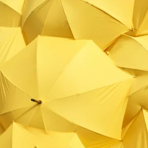 Gemini season yellow umbrellas texture, overhead view of repeated yellow umbrellas creating a vibrant pattern symbolizing movement, curiosity, and mental energy