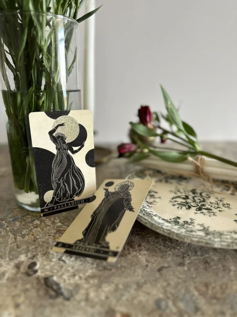 how to shuffle tarot cards represented by two tarot cards on a wooden table in a minimal reading setting