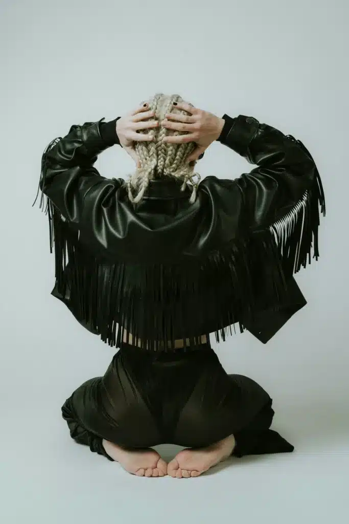 Mars in Aries energy symbolized by a woman seen from behind wearing a black leather jacket, representing courage, strength, and bold action.