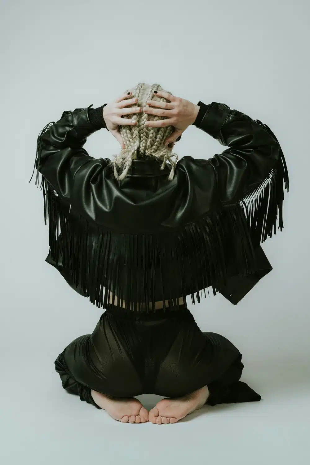 Mars in Aries: Meaning, Energy & How It Affects Each Zodiac Sign Mars in Aries energy symbolized by a woman seen from behind wearing a black leather jacket, representing courage, strength, and bold action.