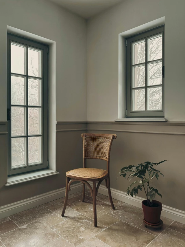 Neptune in the 9th house symbolism with empty room, windows and quiet reflection.