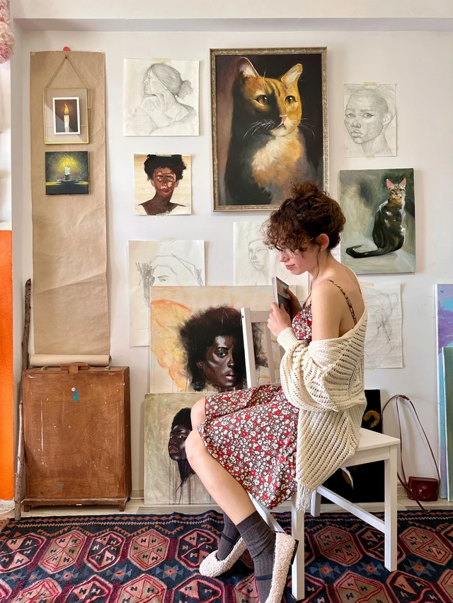 Neptune in the 11th house symbolism with artist surrounded by creative work and community expression.