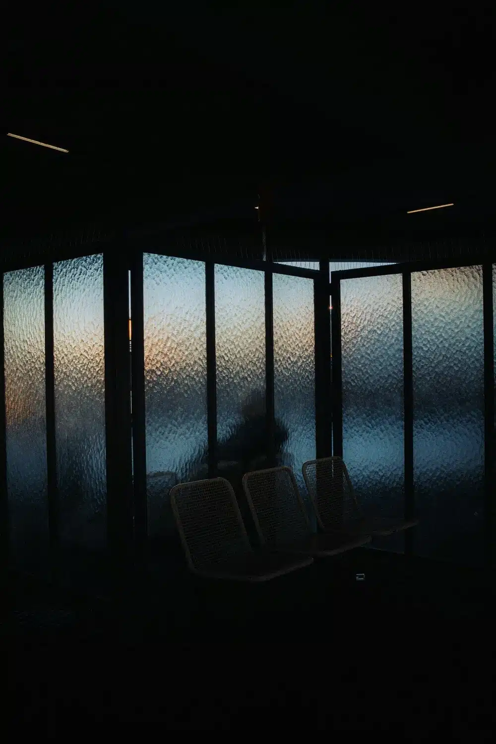 Taurus season grounding energy, dark window at sunset with warm light creating a calm atmosphere.