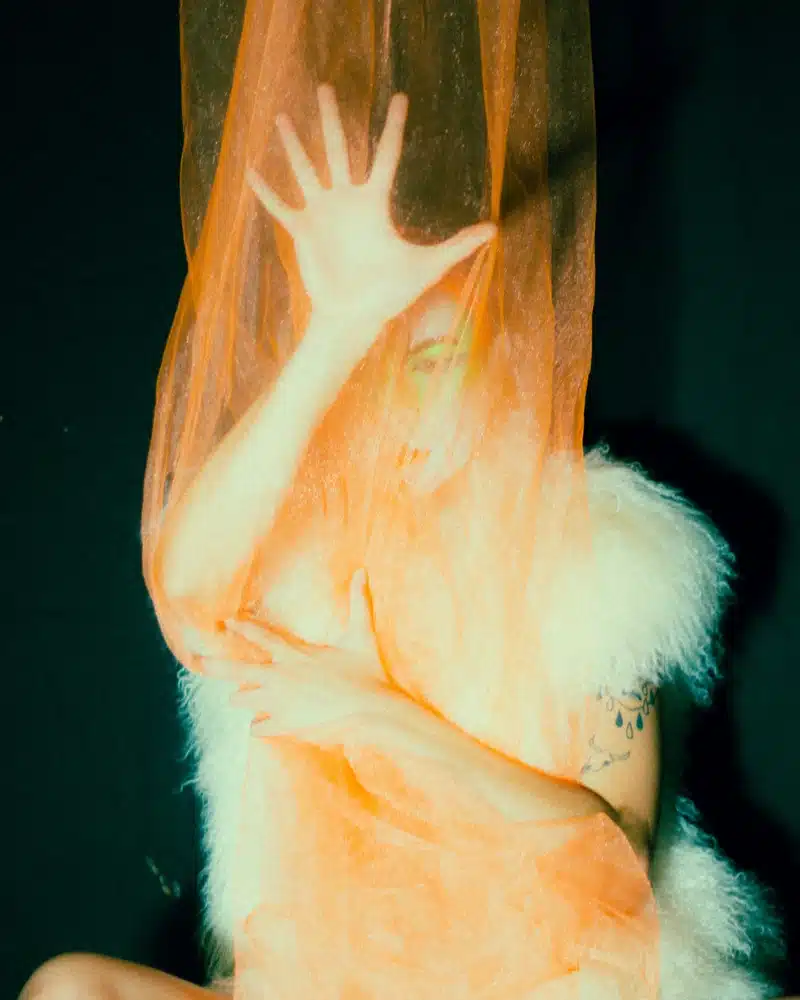 aries rising movement woman with veil in motion, symbolizing mystery, identity, and the shifting expression of the Ascendant