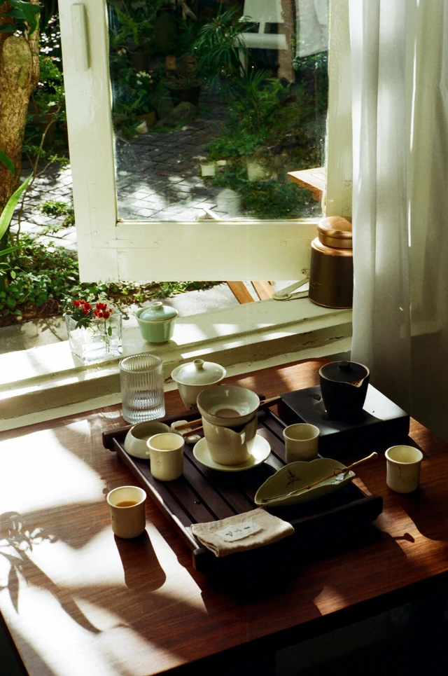 cancer rising home symbolism table by a window with soft natural light, representing safety, protection, and the quiet feeling of home