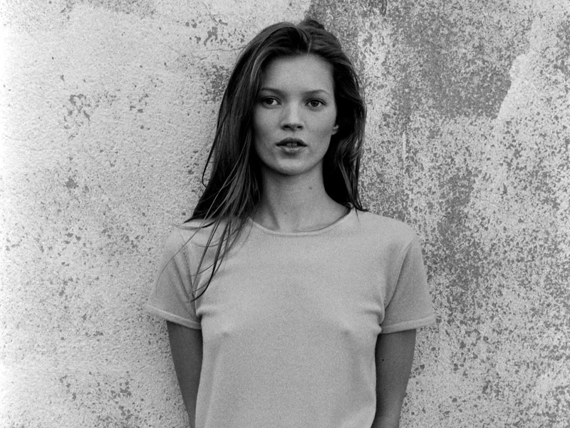 leo rising Kate Moss black and white portrait, expressing quiet confidence, iconic presence, and effortless visibility