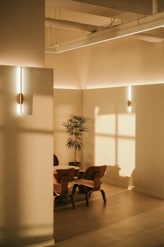 Venus in Leo vibes of a quiet, simple and elegant interior with lights and shadows that comes from a window. 