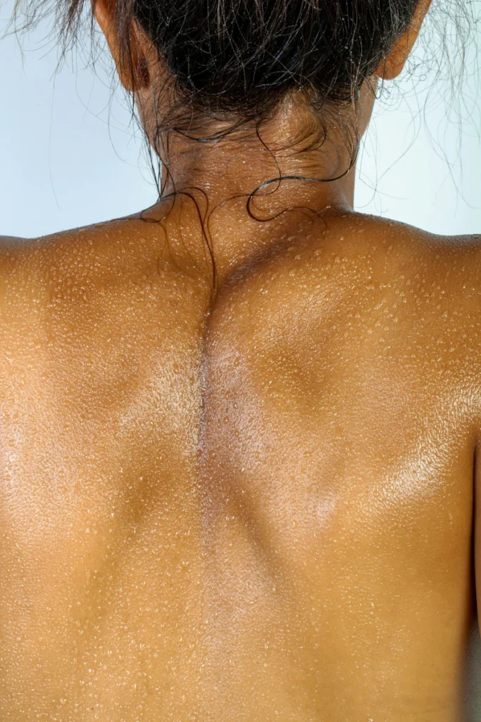 zodiac body parts astrology, woman seen from behind with bare shoulders