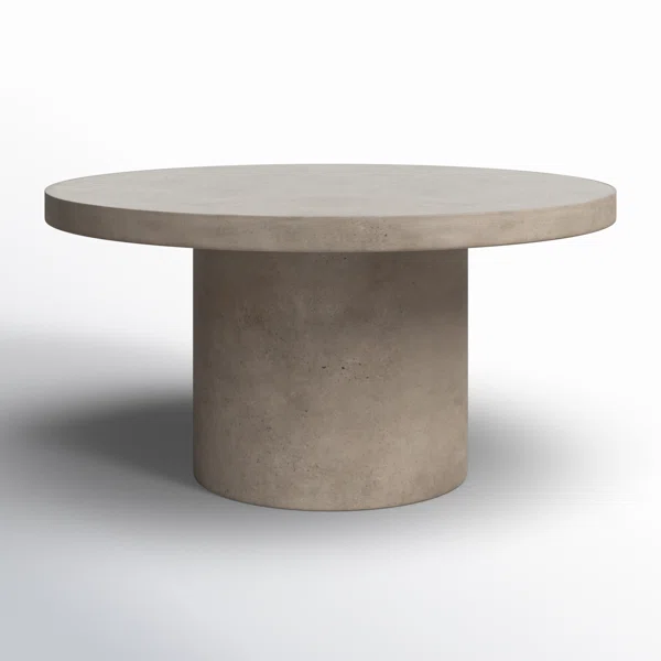 capricorn rising brutalist round concrete coffee table, minimalist architectural design with structured and timeless aesthetic