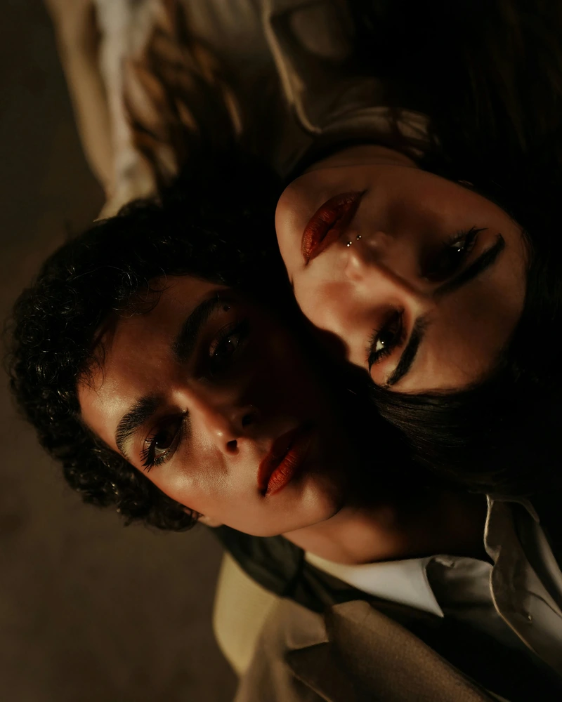 capricorn rising dark overhead portrait of two women looking upward, expressing restraint, depth, structure, and quiet intensity