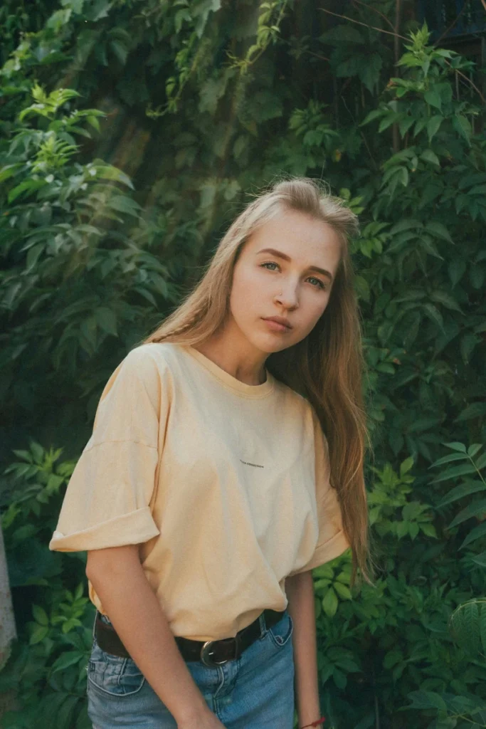 gemini rising portrait girl in yellow shirt with green background, symbolizing contrast, expression, and the lively, adaptable nature of the Ascendant