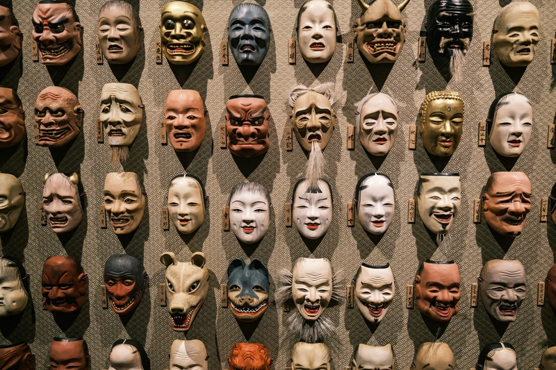 gemini rising symbolism: ancient masks representing duality and shifting identity.