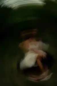 Jupiter in Leo dark abstract motion image with blurred woman in white dress ethereal luminous presence