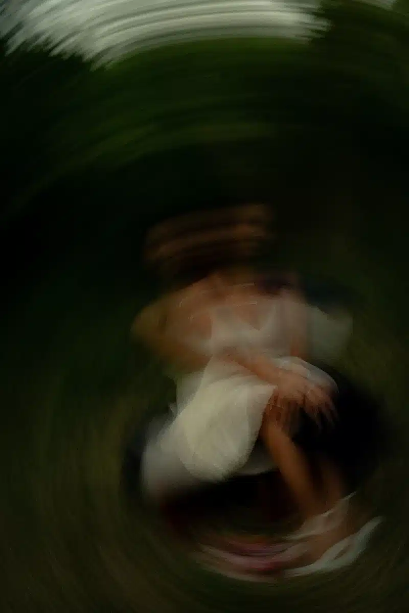 Jupiter in Leo dark abstract motion image with blurred woman in white dress ethereal luminous presence