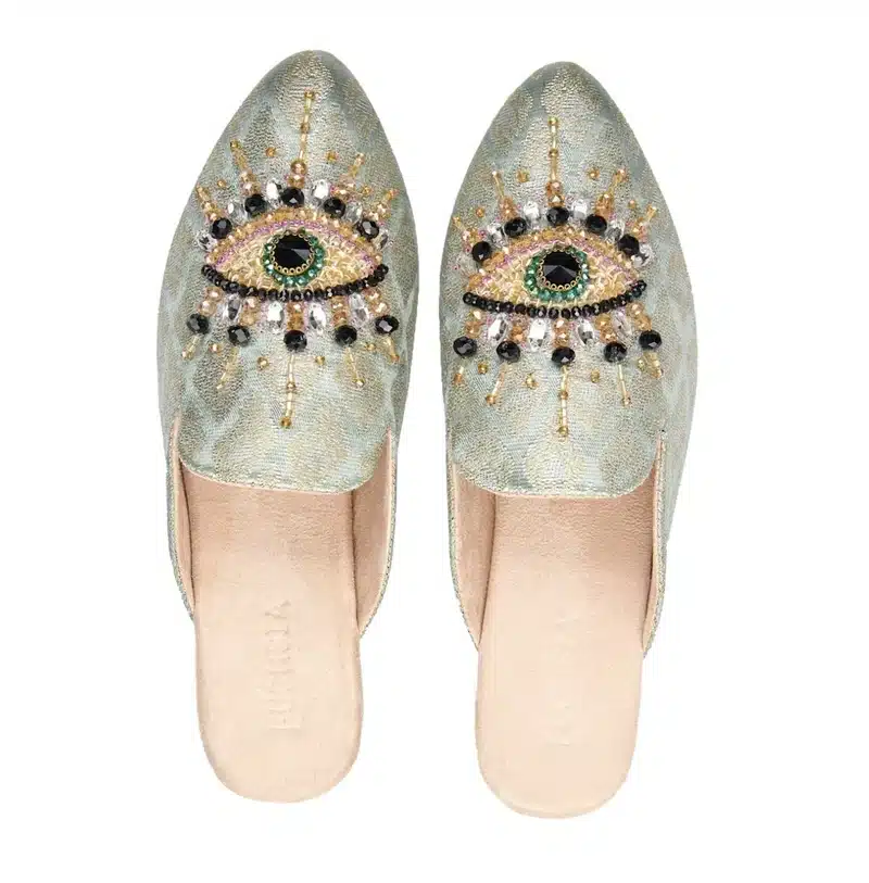 Jupiter in Leo silver shiny slippers with double eye design bold playful statement footwear