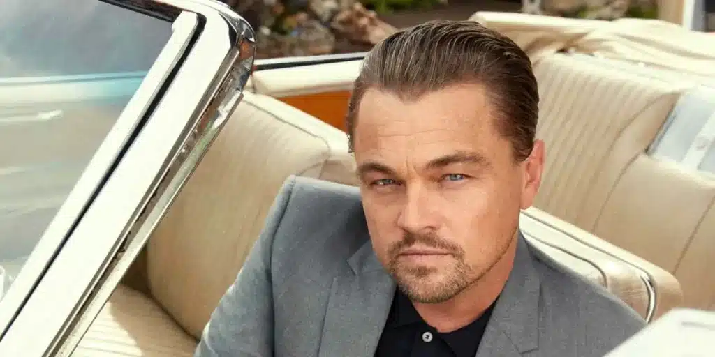 libra rising Leonardo DiCaprio sitting in a car, composed presence and refined features reflecting balance, elegance, and quiet charisma