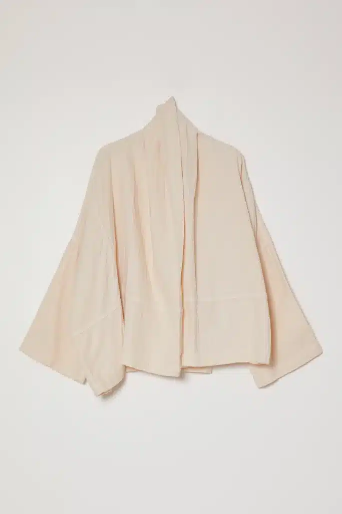 white asymmetric kimono libra rising style, modern silhouette with clean lines, elegant and balanced design
