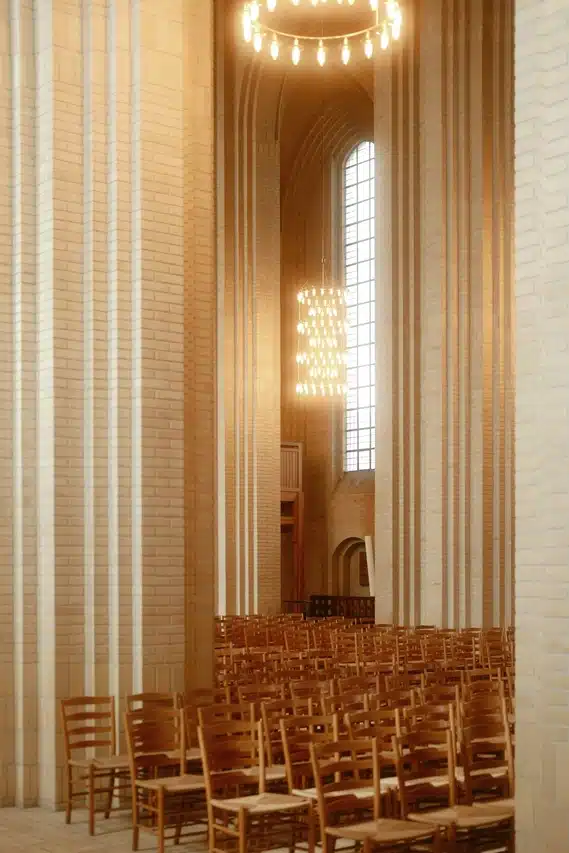 leo season, luminous interior with rows of chairs and sunlight entering the space symbolizing visibility, presence, stage energy, and the courage to be seen