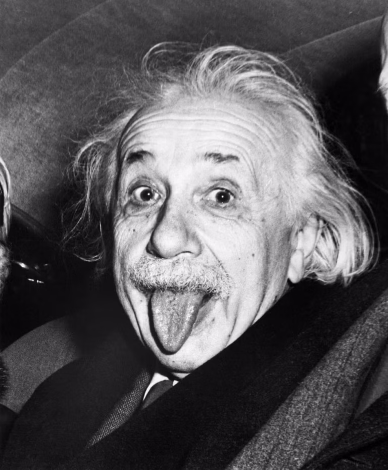 Albert Einstein's black and white famous portrait of him with his tongue out of his mouth.