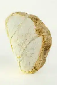 Mars in Cancer mood image featuring a pale textured stone with golden-brown edges, symbolising emotional protection, memory, and inner strength.