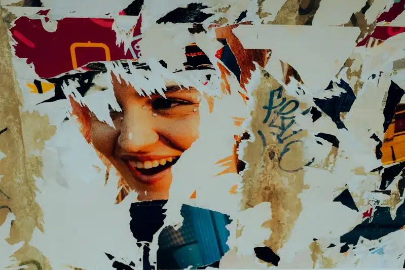 Venus enters Libra image with a torn street poster revealing a smiling face, symbolizing beauty, attraction, and relationship as fragmented reflection.