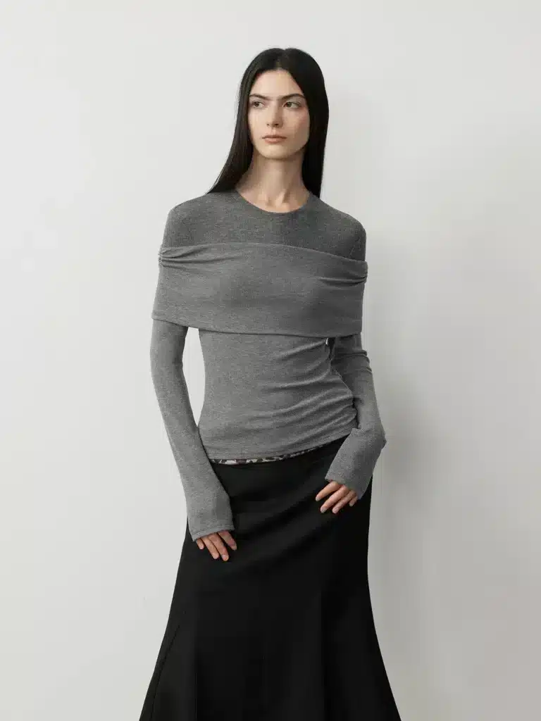 Virgo Season style featuring a grey draped long-sleeve top paired with a long black skirt for a refined, minimalist look.