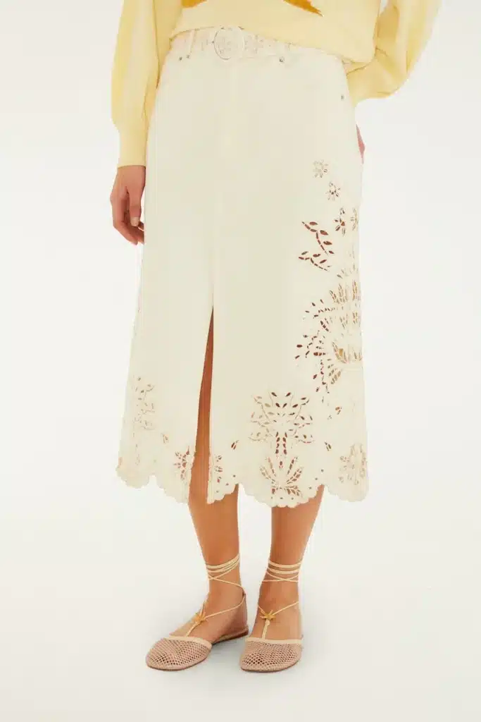 Virgo Season style featuring a cream midi skirt with delicate floral cutwork, a front slit, and neutral lace-up flats.