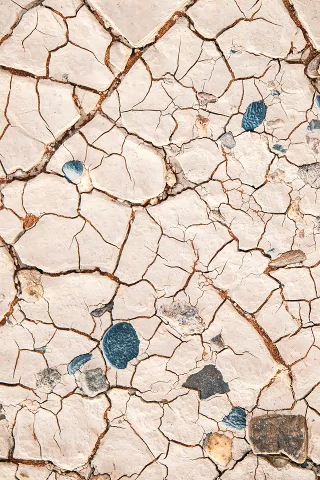 Virgo season represented by cracked earth in soft neutral tones, symbolising discernment, change, observation, and the refinement of what lies beneath the surface.
