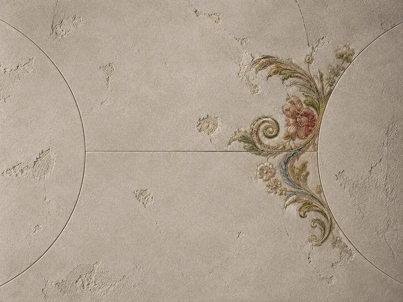 Delicate vintage floral embroidery with pink flowers and gold ornamental details emerging through textured ivory plaster, symbolising personal growth and self discovery through a personalised birth chart reading.