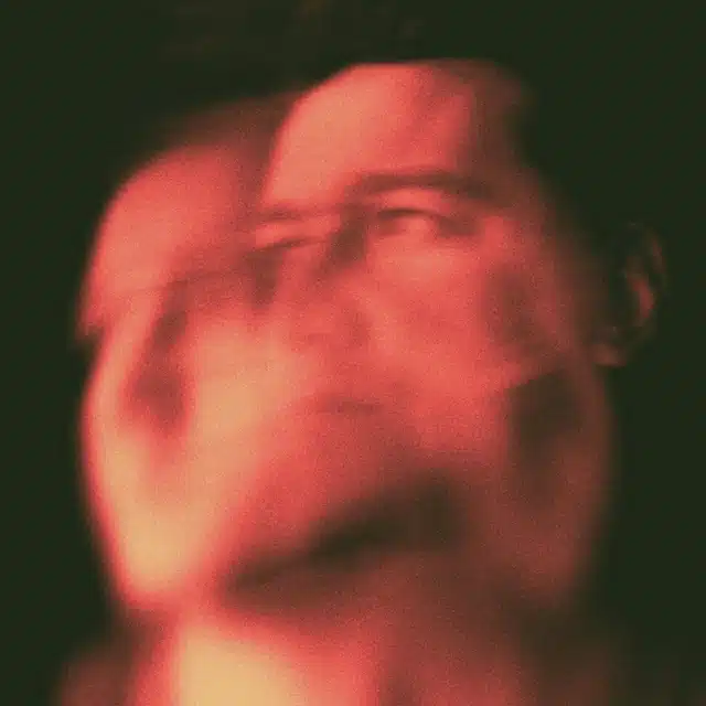 Full Moon in Aries energy represented by a fiery red double-exposure portrait expressing intensity, instinct, and emotional release.
