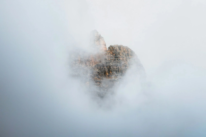 Saturn in Gemini: Meaning, Personality, Challenges And Life Lessons Saturn in Gemini birth chart symbolism represented by a mountain emerging through soft mist and clouds.