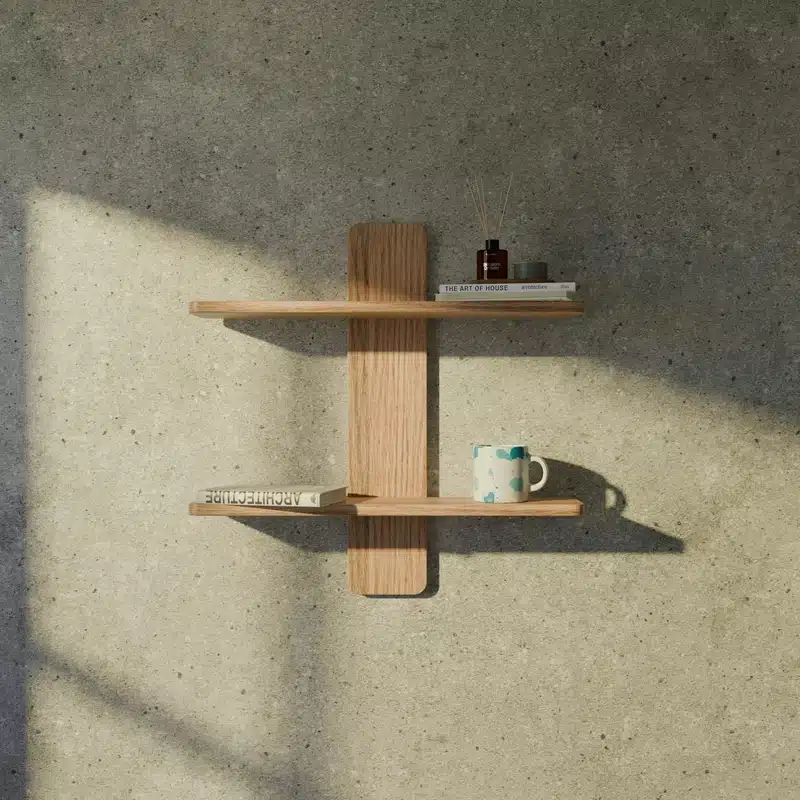 Full Moon in Taurus image with minimalist wooden shelves, books, a ceramic mug, and warm natural light, evoking grounding, simplicity, comfort, and stability.
