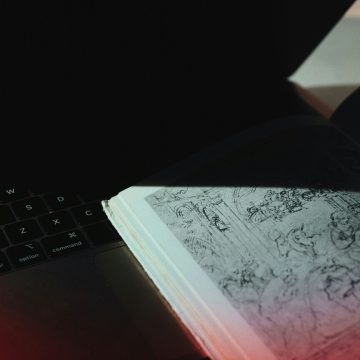 AI birth chart reading concept image with laptop and astrology book.