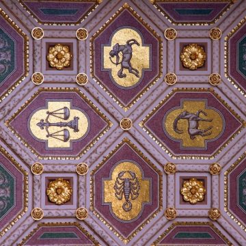 Vibrant purple and golden wall adorned with a beautifully drawn zodiac sign.