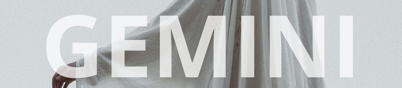 Gemini horoscope banner. Flowing white fabric with a hand reaching out.