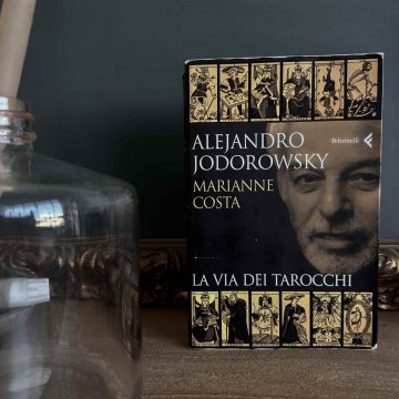 Alejandro Jodorowsky's bestseller 'The Way of Tarot' on a beautiful table with candles.