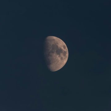 Close-up of the half moon in a dark night sky, symbolizing the Libra New Moon 2025 and its themes of balance and new beginnings.